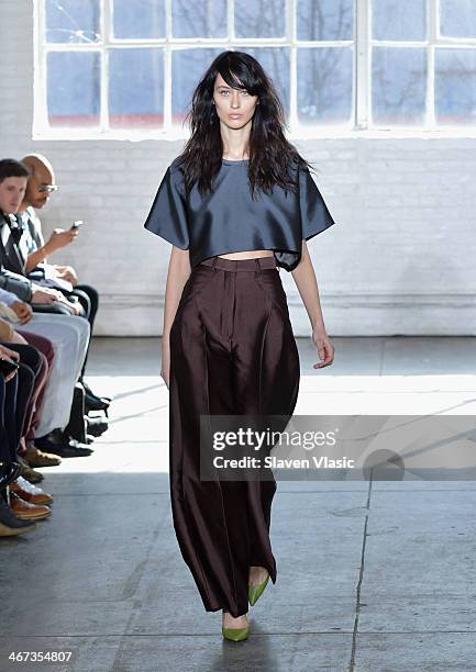 Model walks the runway at the Duckie Brown fashion show during Mercedes-Benz Fashion Week Fall 2014 at Industria Superstudio on February 6, 2014 in...