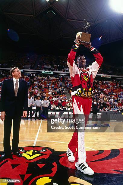 Dikembe Mutombo of the Atlanta Hawks receives the Defensive Player of the Year Award from Rod Thorn, NBA Executive Vice President of Basketball...