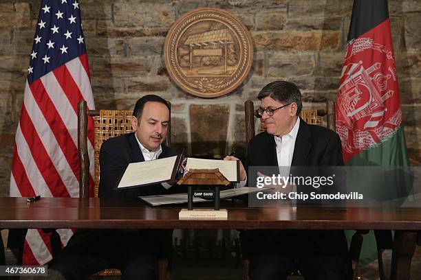 Afghanistan Finance Minister Eklil Hakimi and U.S. Treasury Secretary Jacob Lew exchange copies of a memorandum of understanding during talks at Camp...