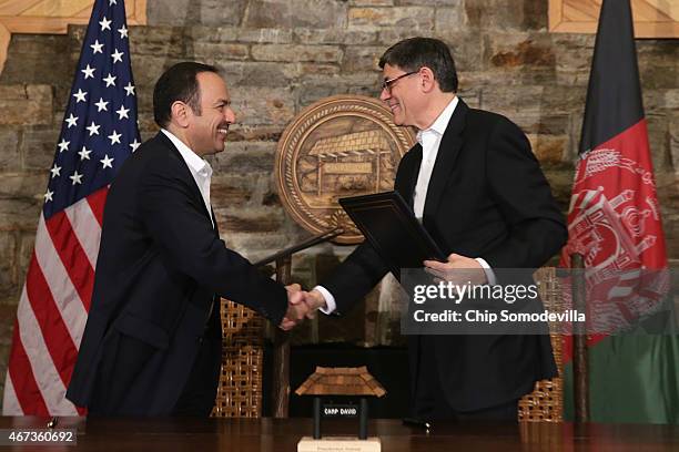 Afghanistan Finance Minister Eklil Hakimi and U.S. Treasury Secretary Jacob Lew shake hands after signing a memorandum of understanding during talks...