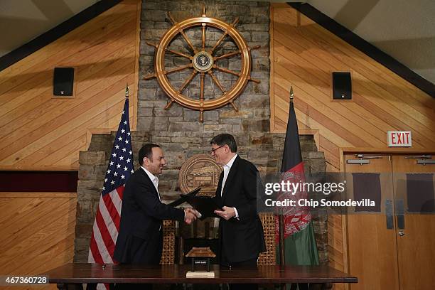 Afghanistan Finance Minister Eklil Hakimi and U.S. Treasury Secretary Jacob Lew shake hands after signing a memorandum of understanding during talks...