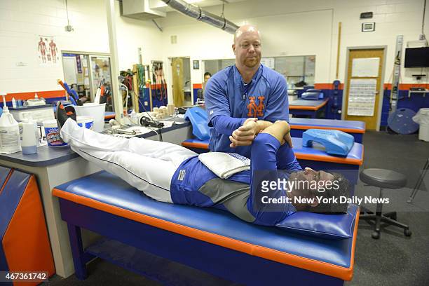 New York Mets starting pitcher Matt Harvey stretching with trainer Dave Pearson.