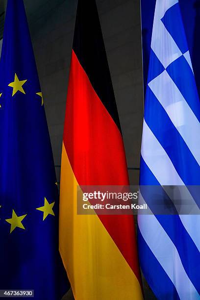 The flags of the European Union, Greece and Germany stays beside as German Chancellor Angela Merkel and Greek Prime Minister Alexis Tsipras speak to...
