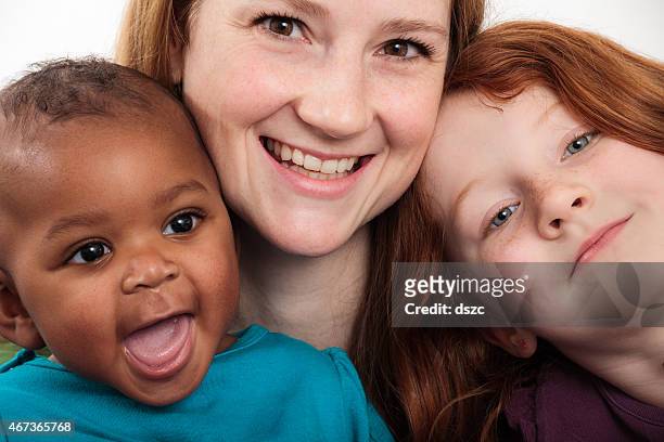 mother and two daughters in adopted mixed race family - freckle girl stock pictures, royalty-free photos & images