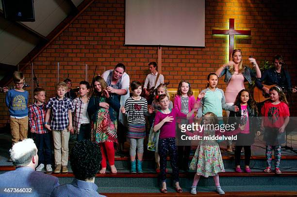 children singing in the church - pentecostalism stockfoto's en -beelden