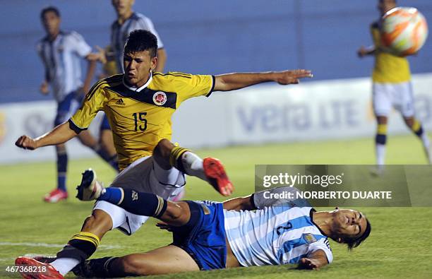 Jorge Carrascal of Colombia and Julian Ferreyra of Argentina fall during their U-17 South American final round football match at Erico Galeano...