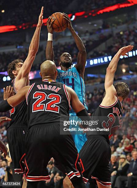 Michael Kidd-Gilchrist of the Charlotte Hornets shoots over Paul Gasol, Taj Gibson and Mike Dunleavy of the Chicago Bulls at the United Center on...