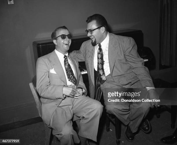 Musicians George Shearing and Al "Jazzbo" Collins backstage at Carnegie Hall on November 11, 1952 in New York, New York.