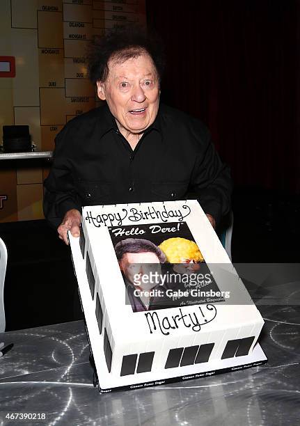 Actor/comedian Marty Allen holds up a cake to celebrate his 93rd birthday during a meet and greet after his performance at the Downtown Grand Hotel &...