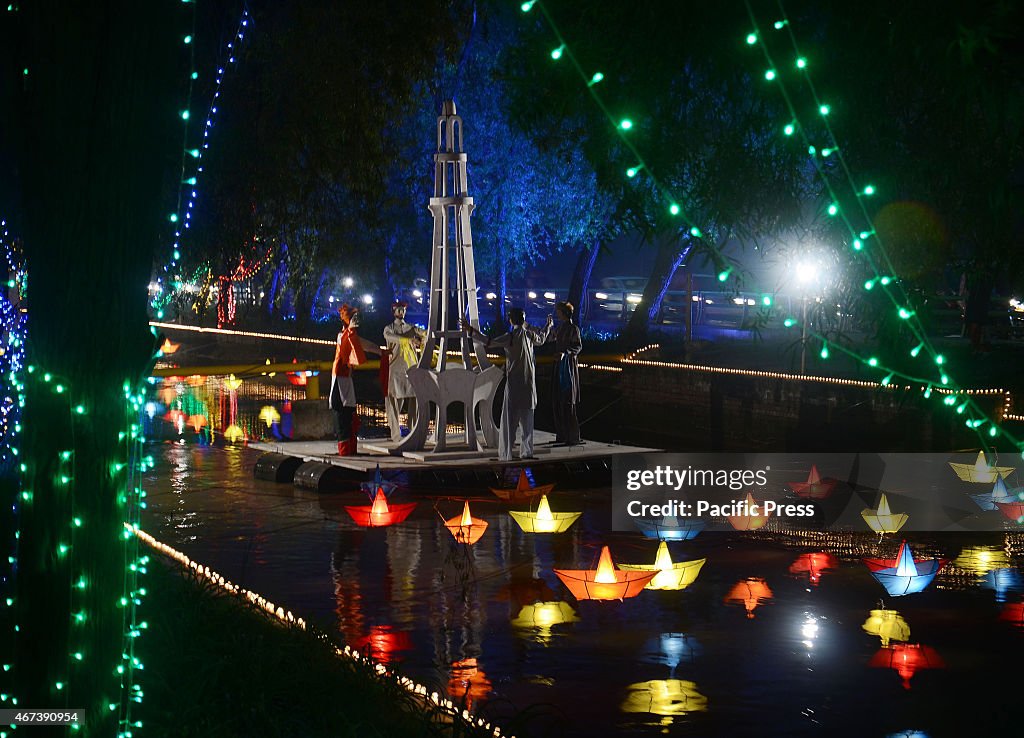 An illuminated view of the floats and lining trees decorated...