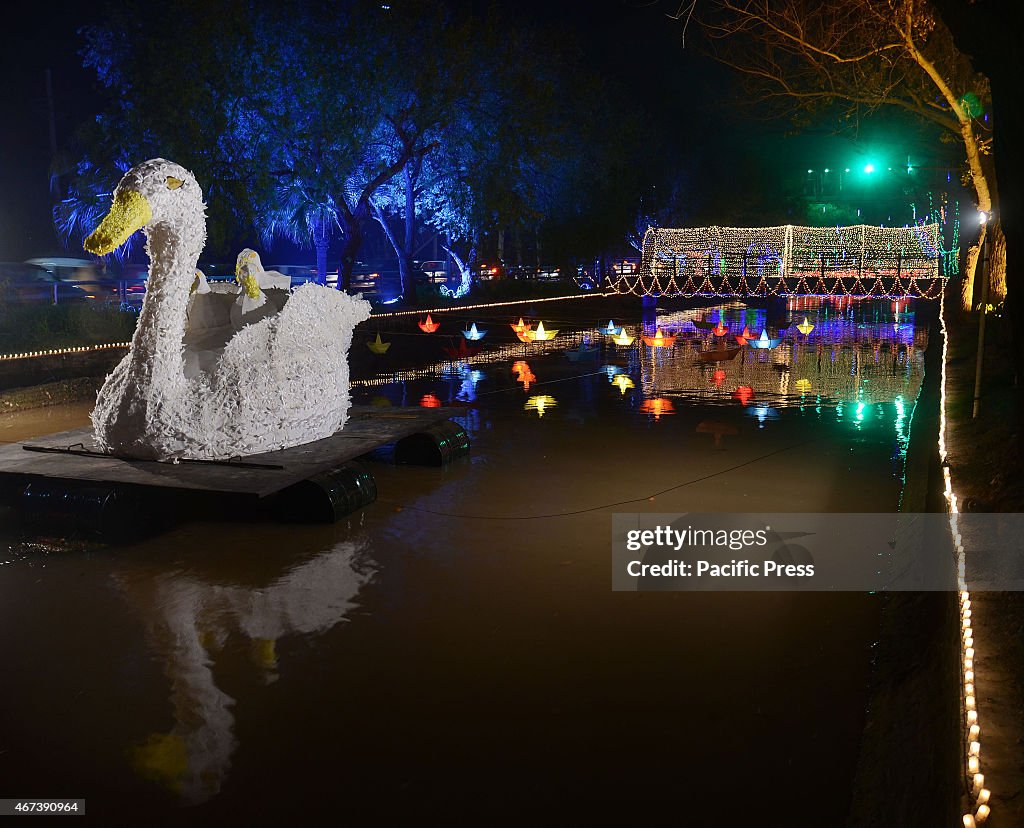 An illuminated view of the floats and lining trees decorated...