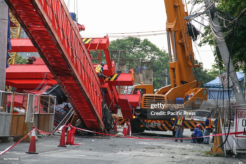 Workers try to secure the collapsed girder launcher before...