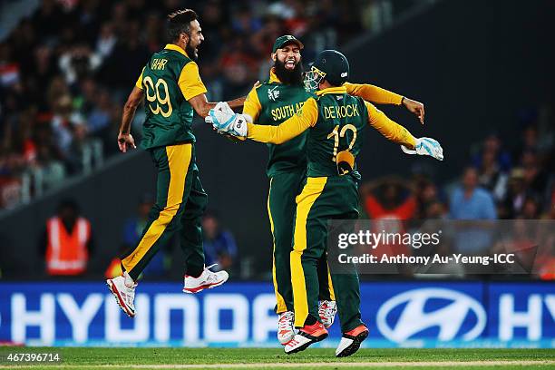 Hashim Amla, Quinton de Kock and Imran Tahir of South Africa celebrate the runout of Martin Guptill of New Zealand during the 2015 Cricket World Cup...