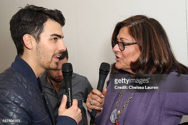 Musician Joe Jonas and Fern Mallis backstage at the Duckie Brown fashion show Mercedes-Benz Fashion Week Fall 2014 at Industria Superstudio on...