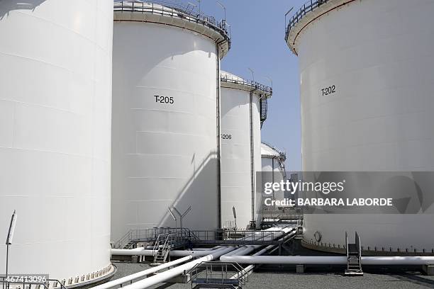 Picture taken on March 24, 2015 shows tanks at the oil storage terminal of VTT Vasiliko Ltd at the port of Vasilikos in the coastal southern Cypriot...