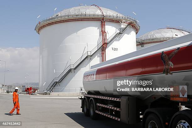 Picture taken from the sea on March 24, 2015 shows a truck arriving at loading area at the oil storage terminal of VTT Vasiliko Ltd at the port of...