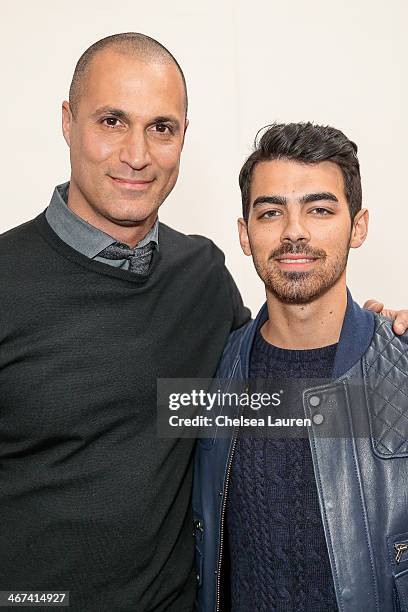 Personality Nigel Barker and musician Joe Jonas attend the Duckie Brown fashion show during Mercedes-Benz Fashion Week Fall 2014 at Industria...