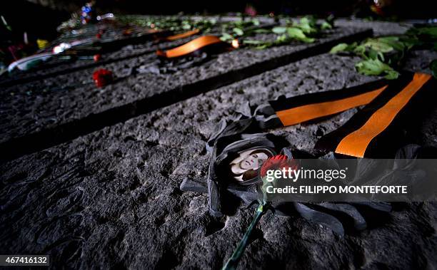 Picture taken on March 24, 2015 in Rome shows a rose laying on a grave of the Ardeatine caves site and memorial cemetery on the 71st anniversary of...