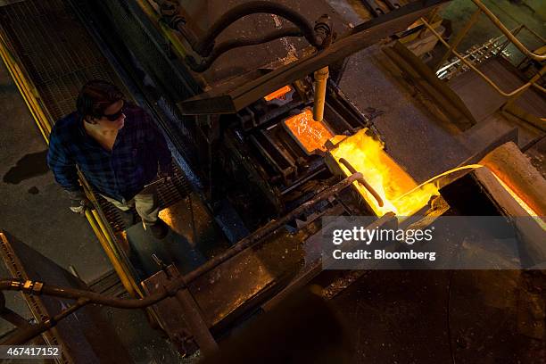 Worker watches as molten silver flows from a ladle into a mould at the KHGM Polska Miedz SA smelting plant in Glogow, Poland, on Monday, March 23,...