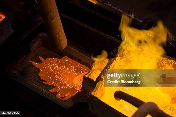 Red hot molten silver flows from a ladle into a mould at the KHGM Polska Miedz SA smelting plant in Glogow, Poland, on Monday, March 23, 2015. KGHM...