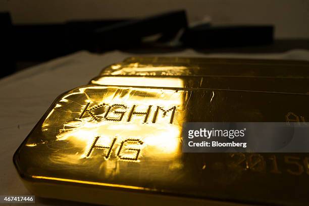 Mark sits on a newly cast gold bullion bar ahead of export at the KHGM Polska Miedz SA smelting plant in Glogow, Poland, on Monday, March 23, 2015....