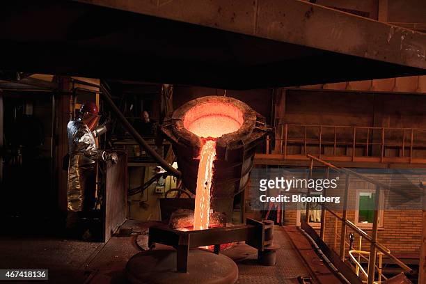 Worker watches as molten silver is poured from a ladle before being cast at the KHGM Polska Miedz SA smelting plant in Glogow, Poland, on Monday,...