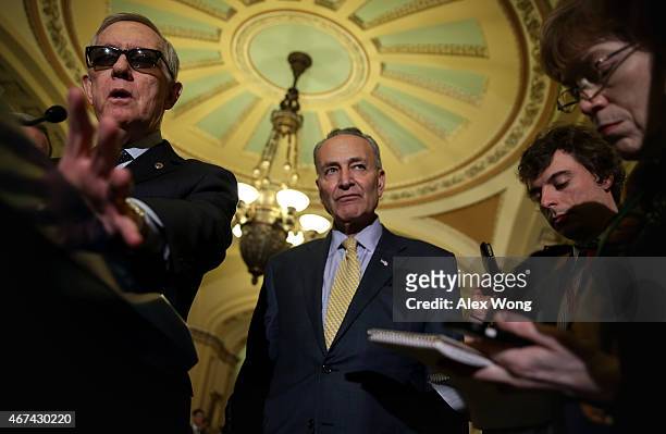 Minority Leader Sen. Harry Reid speaks to members of the media as Sen. Charles Schumer listens after the weekly Democratic Policy Luncheon March 24,...