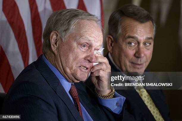 Golfer Jack Nicklaus wipes a tear as House Speaker John Boehner,R-OH, looks on during a Congressional Gold Medal ceremony on Capitol Hill March 24,...