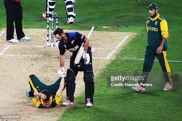 Grant Elliott of New Zealand helps Dale Steyn of South Africa up after winning the 2015 Cricket World Cup Semi Final match between New Zealand and...