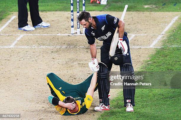 Grant Elliott of New Zealand helps Dale Steyn of South Africa up after winning the 2015 Cricket World Cup Semi Final match between New Zealand and...