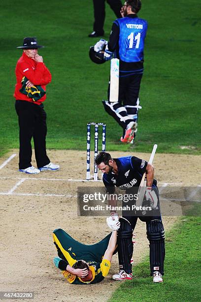 Grant Elliott of New Zealand helps Dale Steyn of South Africa up after winning the 2015 Cricket World Cup Semi Final match between New Zealand and...