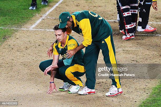 Dale Steyn of South Africa is comforted by Imran Tahir of South Africa after losing the 2015 Cricket World Cup Semi Final match between New Zealand...