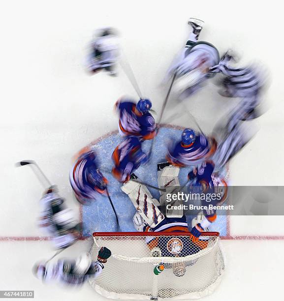 Jaroslav Halak of the New York Islanders lies on the puck as action swirls around him during the second period against the Minnesota Wild at the...