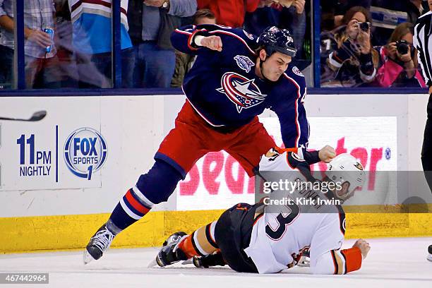 Jared Boll of the Columbus Blue Jackets throws a punch against Clayton Stoner of the Anaheim Ducks during the second period on March 24, 2015 at...