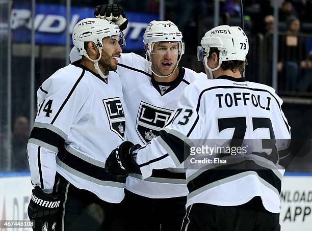 Justin Williams and Tyler Toffoli of the Los Angeles Kings congratulate Jeff Carter after he scored in the third period against the New York Rangers...