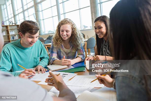 students studying for test with large study group in library - children looking graph stock pictures, royalty-free photos & images