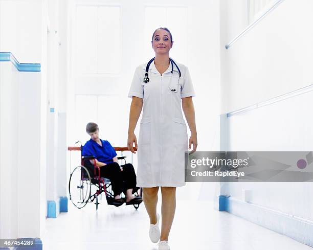 smiling nurse walks away from sleeping woman in wheelchair - nurse ignoring patient stock pictures, royalty-free photos & images