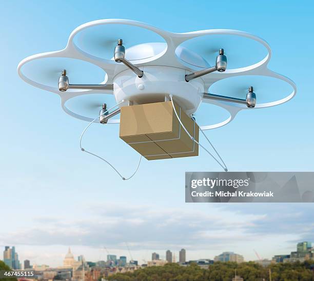 delivery drone carrying package on a city - drone parcel stock pictures, royalty-free photos & images