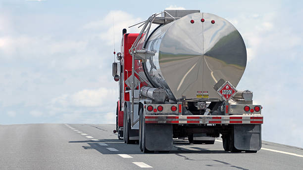 A tanker truck with a "Flammable" sticker on the back of the tank.