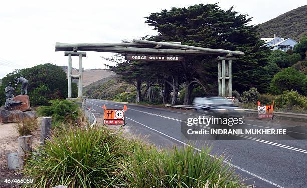 In this photo taken on March 24 a car passes beneath the Memorial Arch of the Great Ocean Road in Victoria. The 243 kilometres Australian National...