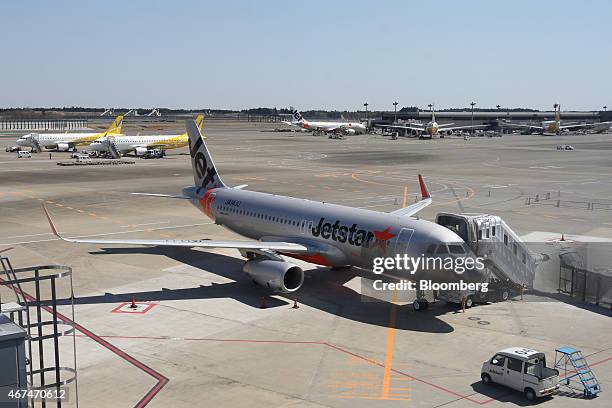 Jetstar Japan Co. Aircraft, front, and Vanilla Air aircraft, left, sit parked at Terminal 3 of Narita Airport in Narita, Japan, on Wednesday, March...