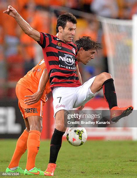 Jerome Polenz of the Roar and Labinot Haliti of the Western Sydney Wanderers challenge for the ball during the round 21 A-League match between...