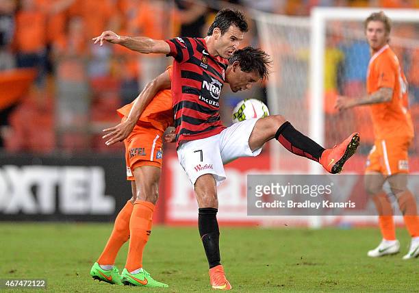 Jerome Polenz of the Roar and Labinot Haliti of the Western Sydney Wanderers challenge for the ball during the round 21 A-League match between...