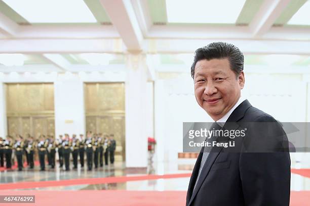 Chinese President Xi Jinping accompanies Armenian President Serzh Sargsyan to view an honour guard during a welcoming ceremony inside the Great Hall...