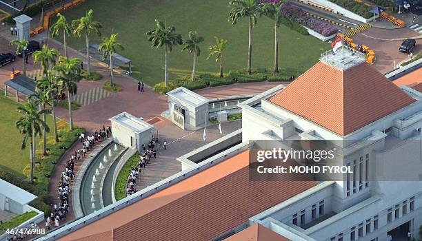 The Singaporean national flag on top of Parliament House is seen at half mast as members of the public queue up outside to pay their respects to the...