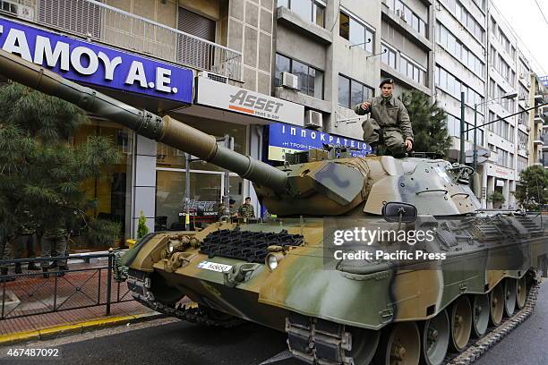 Soldier poses on top of a a German Leopard 1 Main Battle Tank ahead of the military parade in Athens. The participants of the military parade that is...