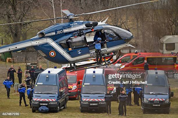 Rescue workers and gendarmerie via helicopter continue their search operation near the site of the Germanwings plane crash near the French Alps on...