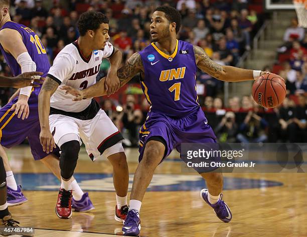 Deon Mitchell of the UNI Panthers drives against Quentin Snider of the Louisville Cardinals during the third round of the 2015 Men's NCAA Basketball...