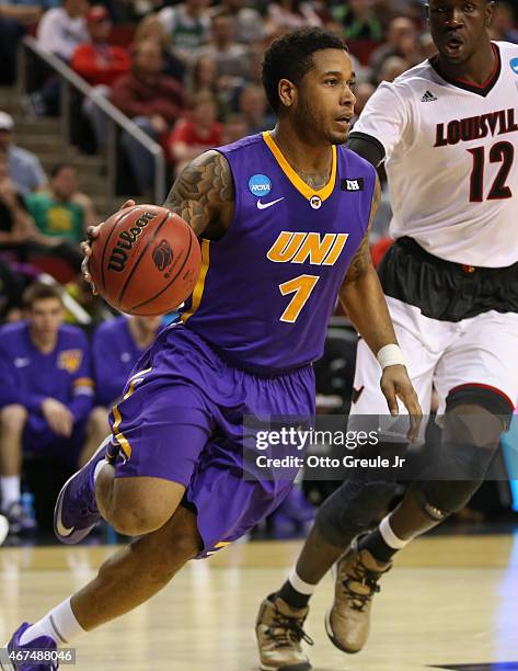 Deon Mitchell of the UNI Panthers dribbles against Mangok Mathiang of the Louisville Cardinals during the third round of the 2015 Men's NCAA...