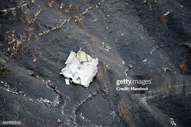 In this handout image supplied by the Ministere de l'Interieur , search and rescue teams attend to the crash site of the Germanwings Airbus in the...